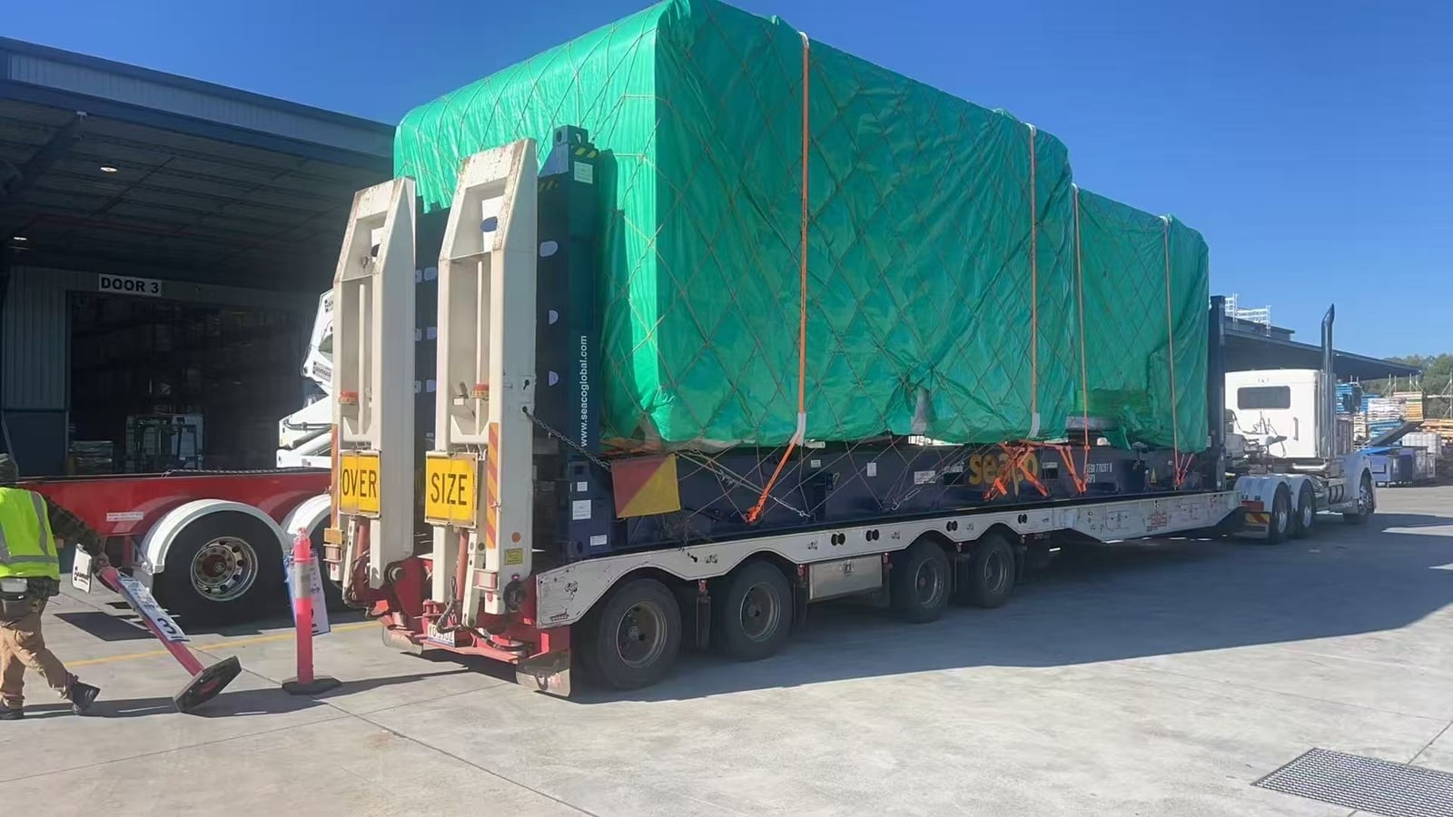 Portable buildings on a low-loader trailer